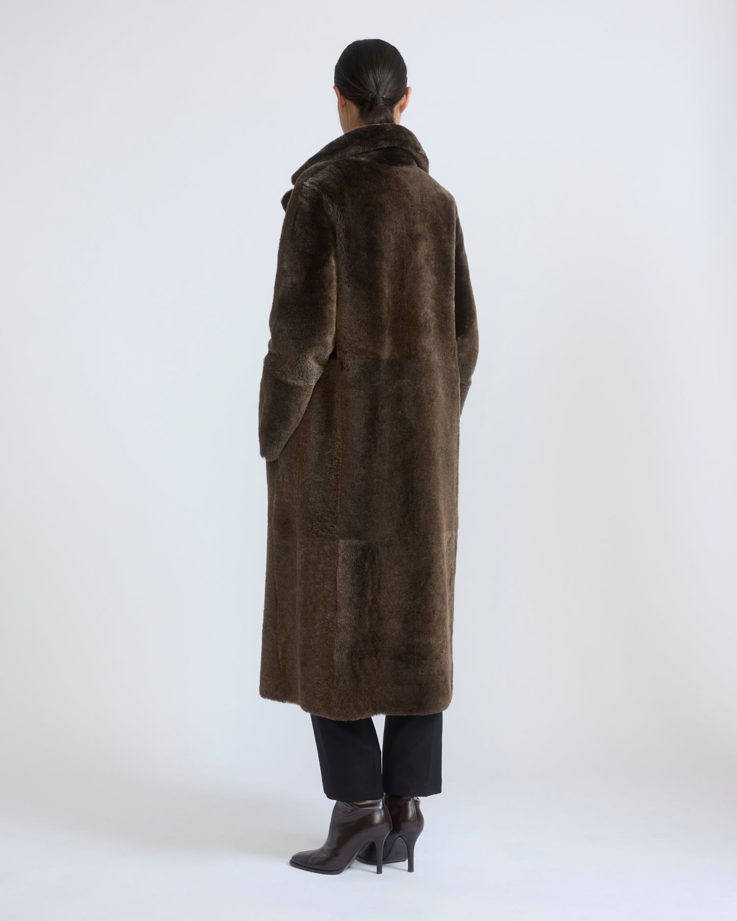Reversible belted long shearling coat