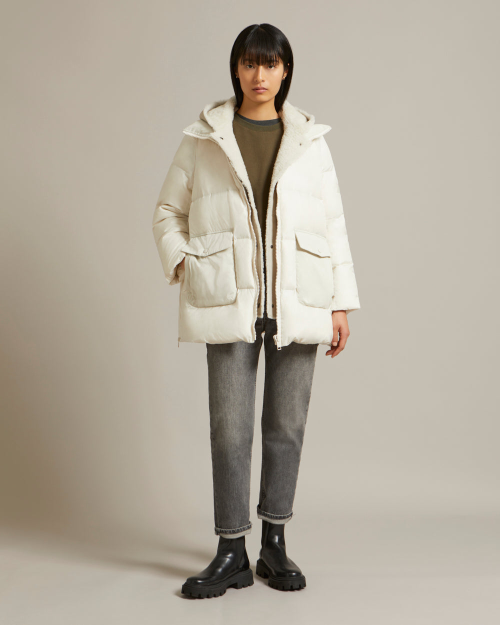 A line down jacket in a mix of technical fabrics with merino shearling hooded bib