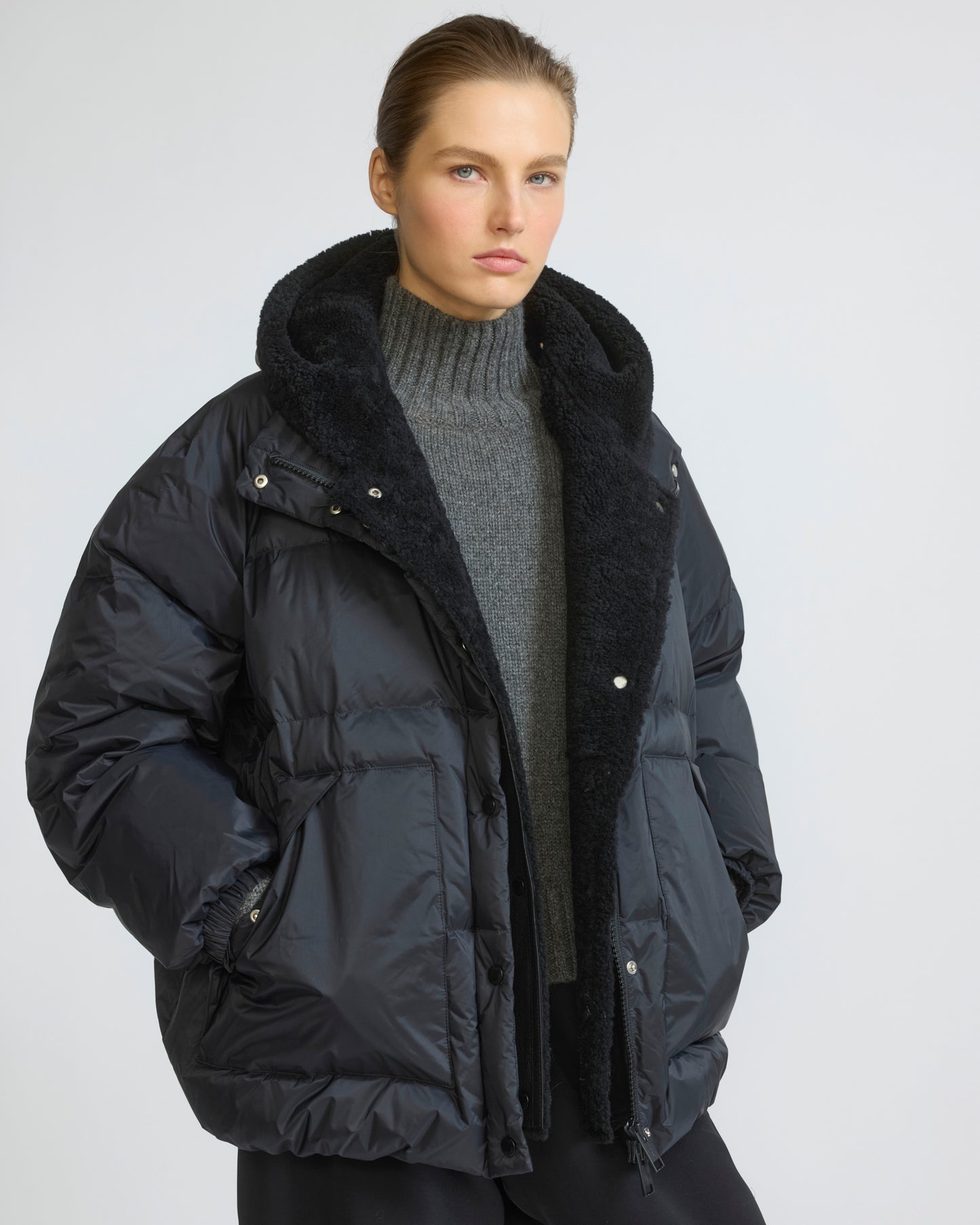 Short down jacket in waterproof technical fabric with lambskin shearling bib panel