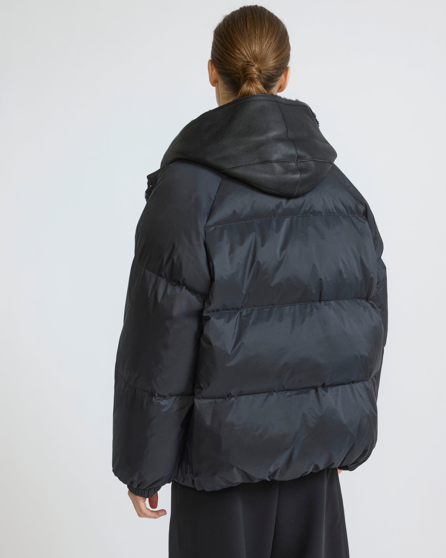 Short down jacket in waterproof technical fabric with lambskin shearling bib panel
