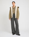 Revrsible hooded jacket in lambskin shearling and technical fabric