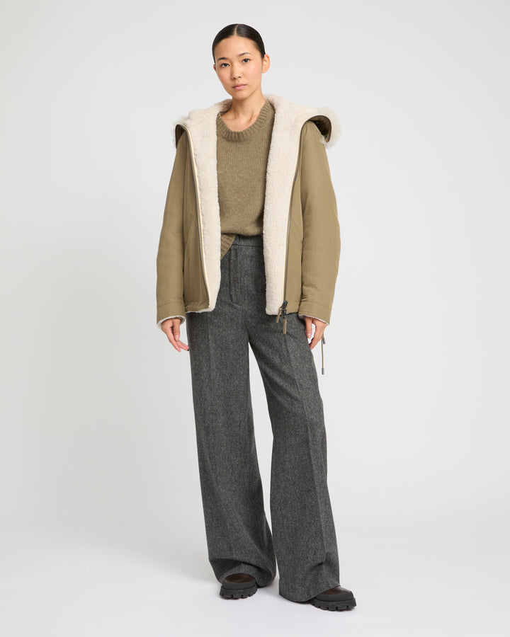 Revrsible hooded jacket in lambskin shearling and technical fabric