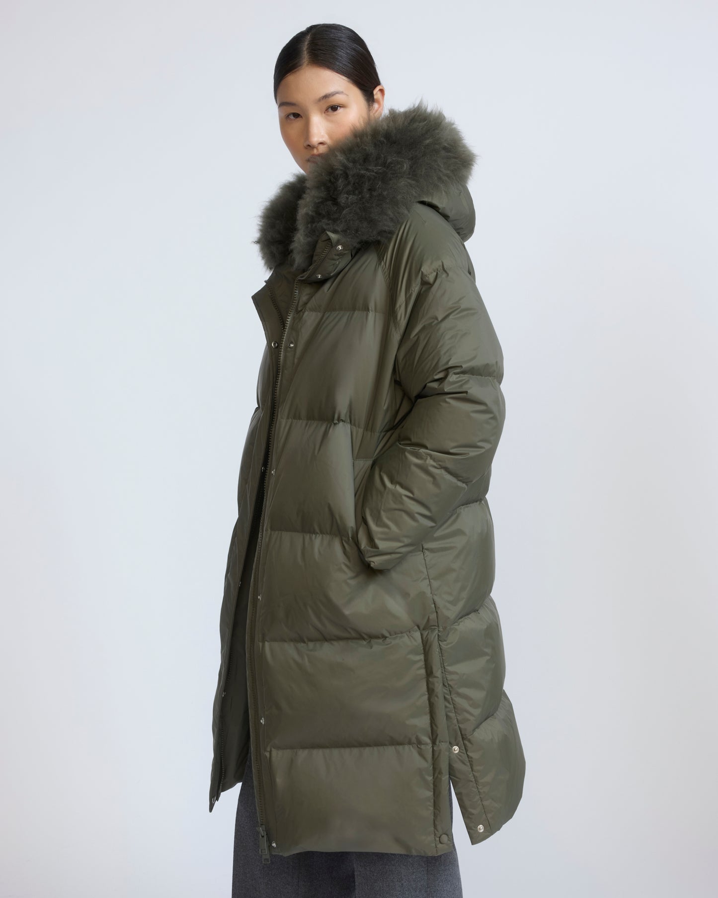 Long down jacket in waterproof technical fabric with airy lamb wool trim