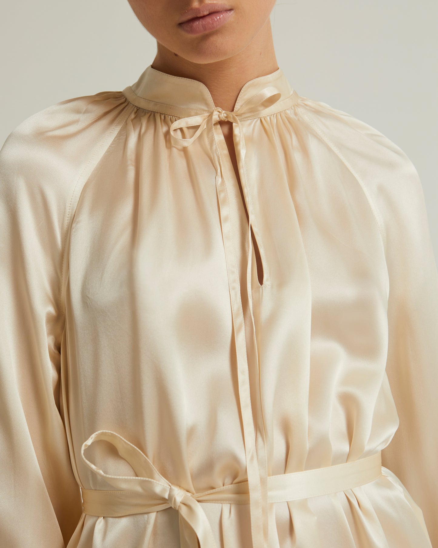 Flowing dress with long sleeves in silk satin
